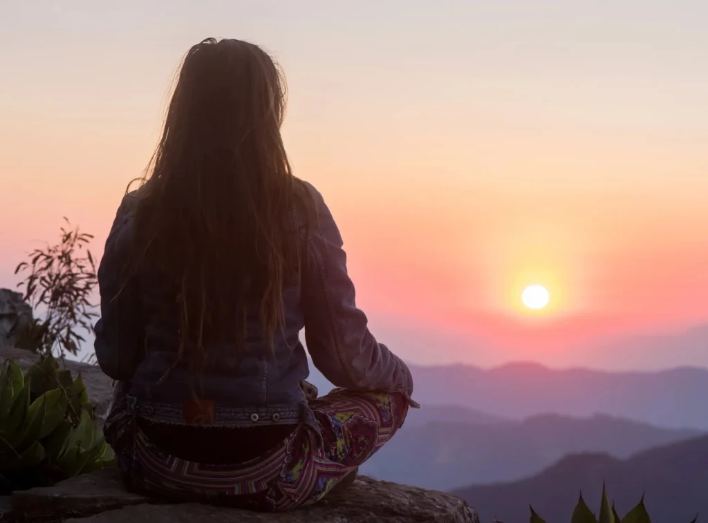 woman meditating mountain sunrise landscape